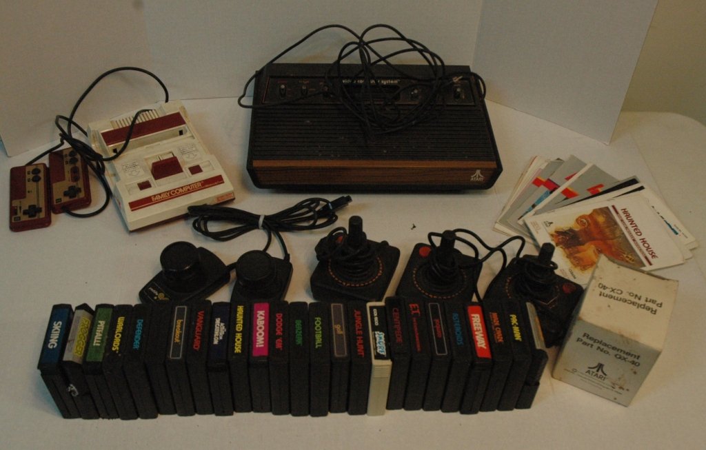 Vintage Japanese Nintendo & Atari 2600 lot: Original Japanese "Family Computer Nintendo" Entertainment System. Plus Original Atari 2600 that comes with 25 games 3 used controllers. & one unsued in the BOX. one paddle controller over 15 game man