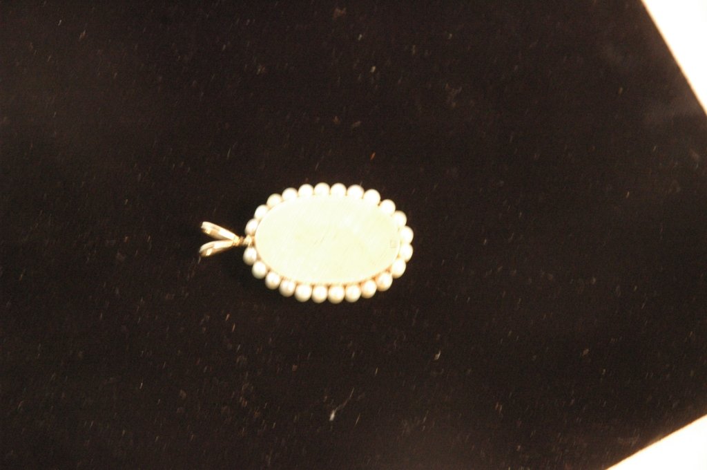 Antique 14kt gold Locket with diamonds and pearls: 6 Diamonds set in 14kt etched stars. Locket is oval in shape and has a round front that is 1/2" deep with lace edging. Weight:14.30