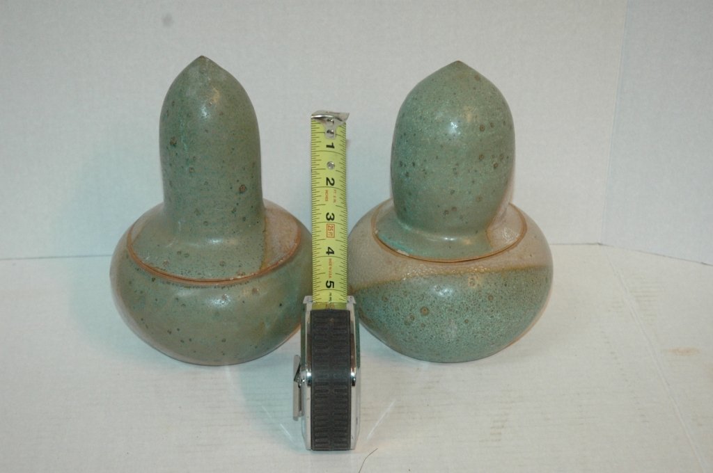 2 Unique Bullet Lid Shaped Pottery Signed: Designer pottery signed " Pam " (Pam M. Yetish) Both with bullet shaped tops and round bases. Both are appraxamite 7" X 6". 1 of three P.M.Y. lots