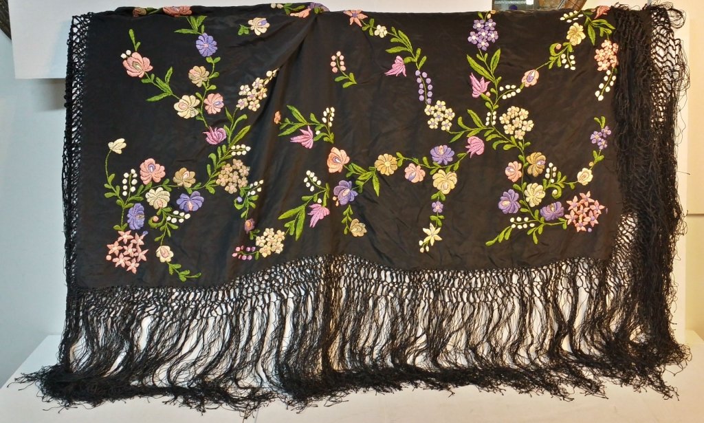 A fine quality antique embroidered piano shawl: The black background shawl embroidered with colorful flowers. Appx. 50" x 48", measured without fringe.