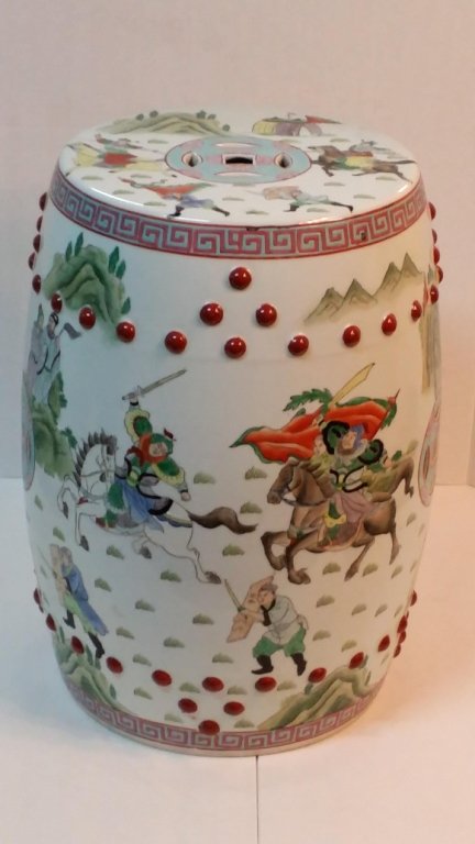 A Fine Quality Chinese Garden Seat: A garden seat decorated with scenes of warriors on horseback