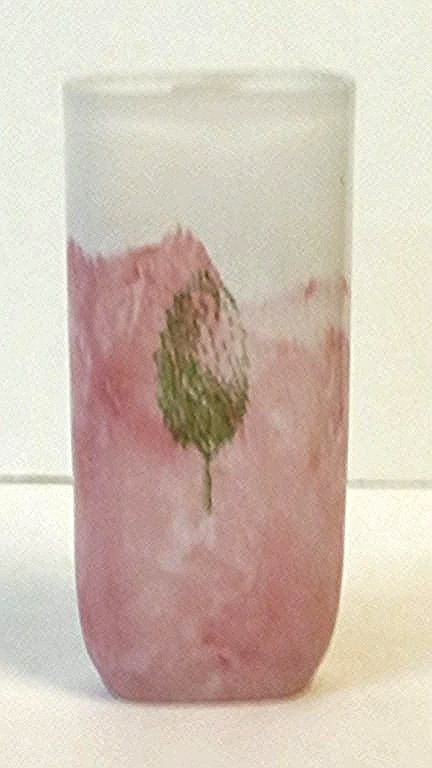 Kosta Boda Kjell Engman Vase: A pink vase with a green tree, signed by Kjell Engma, appx. 7" tall.