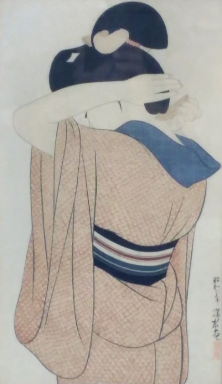 Japanese woodblock print of a woman. Signed: Japanese woodblock print of a woman fixing her hair. signed. small hole.