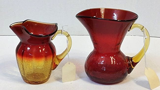 2 piece Ruby Amber crackle glass collection: Large pitcher is all ruby glass with a amber handle. stands 6" tall Small Pitcher is a ruby and amber blend. Stands 5.25 tall both are thick glass