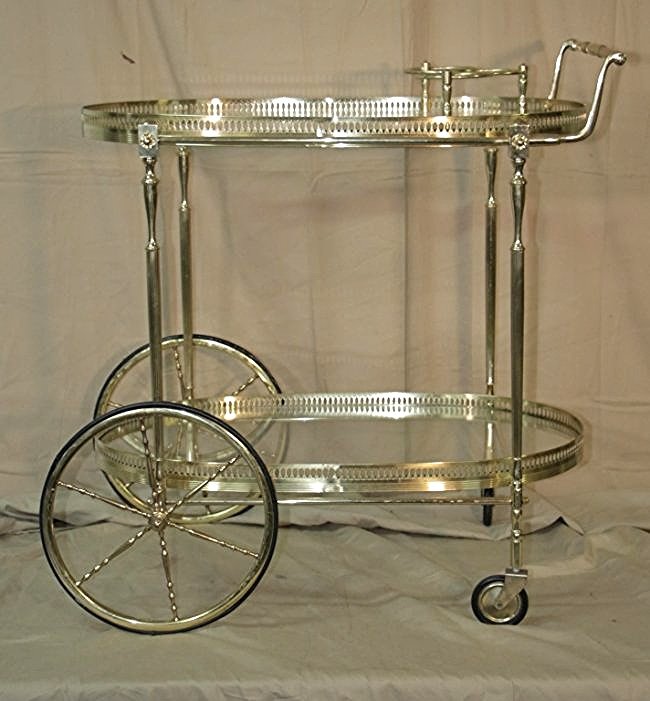 Italian Brass & Glass Tea or Liquor Serving Cart: Mid century Italian brass and glass serving cart. With holders for wine or liquor bottles. Measurements: 28" x 19" x 31" Period: Mid century
