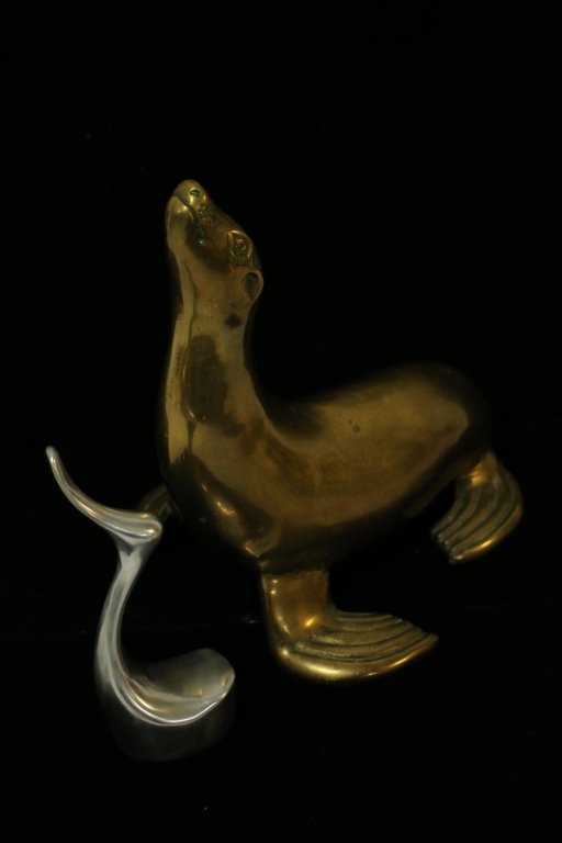 Bonze Sea Lion with Modern Silver Duck Statue: The Duck is illegible signed on the bottom 6.5" tall. The se lion is 10" X 10" X 8" wide.