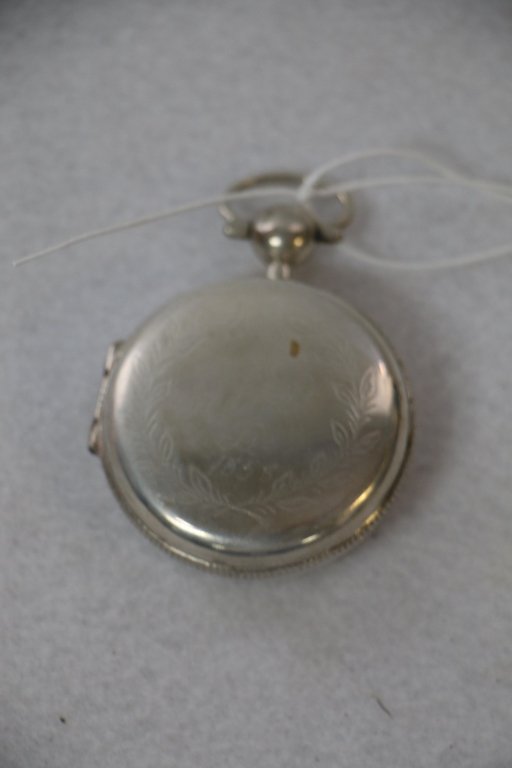 A Silver vinaigrette: An antique sterling silver (?) Vinaigrette. Marked "IGA" on the interior of the cover and on the inside of the case. Inscribed on the front "M O D/ B/ 1858" in a wreath of leaves.
