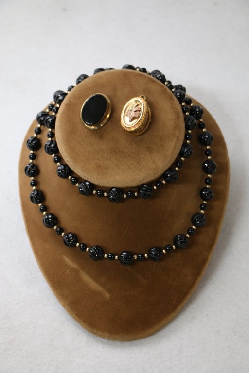 Antique Jewelry Lot: Strand of onyx carved beads with gold (?) spacers, antique gold filled locket with tri color gold leaf decoration, antique gold filled onyx pin.