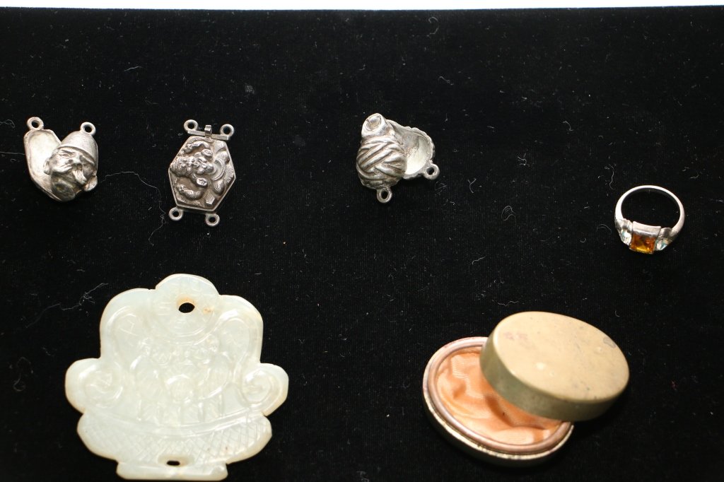 Chinese lot- silver, jade, metal, etc.: An oval Chinese box with signature, a carved jade plaque with figures, 3 figural silver (?) charms.