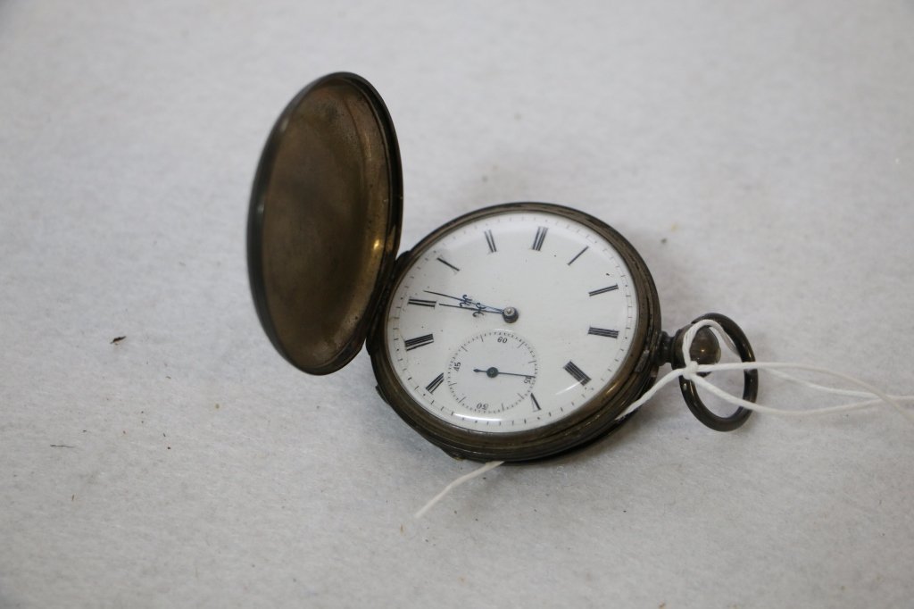A silver cased pocket watch with fancy case: The silver cased watch with decorations of a courting couple, hunting case. Keywind movement.