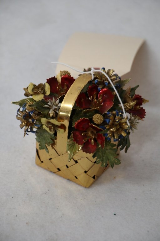 A Cartier flower basket by Jane Hutcheson: A decorative floral enameled basket. Labeled "Designed by/ Jane Hutcheson/ for/ Cartier". Appx. 3 1/8" tall overall.