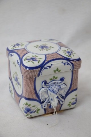 A Tiffany & Co. Porcelain box: A fine quality Tiffany & Co. box. Signed "Tiffany & Co. / Private Stock / Hand Painted / Made in France". Some other marks. Well sculpted elephant handles. Appx 5" x 5" x 5".