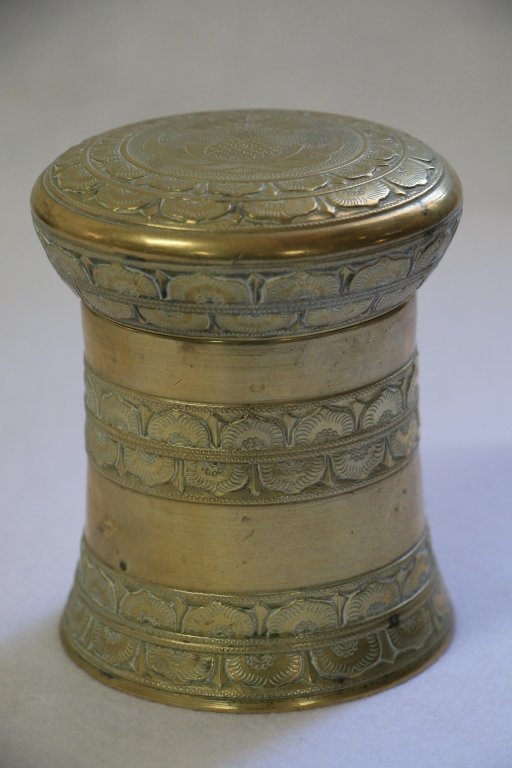 A Fine quality Indonesian (?) brass lidded box: The round jar with a tight fitting lid. 4.5" tall overall, 4" diameter. Heavy, well made, well engraved. Brass or bronze, certainly antique.