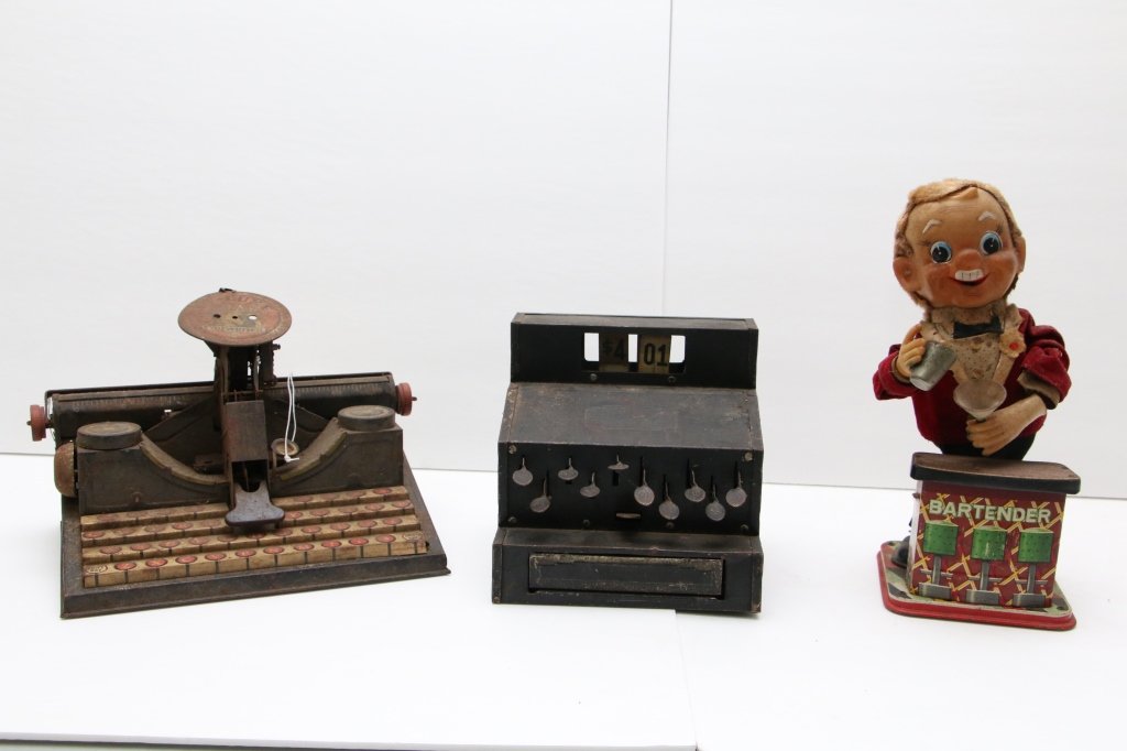 Vintage Metal Toy Lot; MARX, Earl, Bartender: An EARL Toy cash register, the MARX De-Luxe Dial Typewriter, and the classic Bartender mechanical toy. all as found.