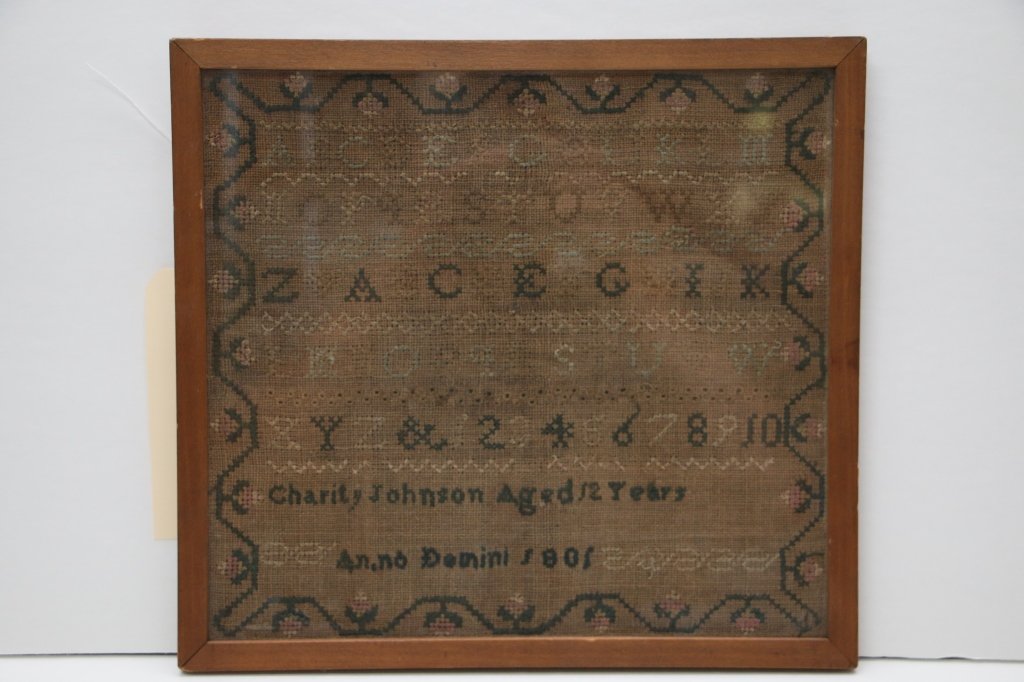 Antique American Sampler, 1801: Charity Johnson, Aged 12 years, Anno Domini 1801. Somewhat dark and faded, appx. 9.75" x 10.75" sight size. Antique Frame. With antique "W. C. Dibble" label verso.