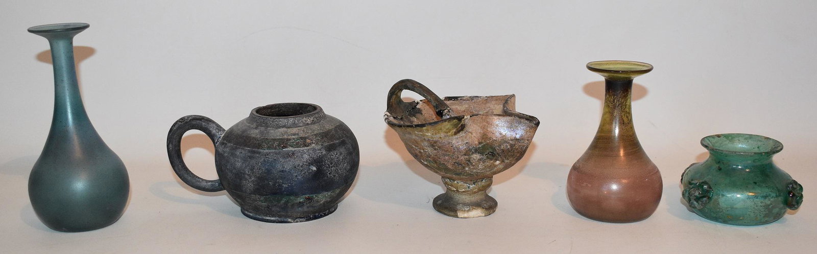 5 ANCIENT ANTIQUITIES INC. POTTERY FLUID LAMP, C. BC: LOT (5) ANCIENT ANTIQUITIES INCL. POTTERY FLUID LAMP, BLACKWARE GLAZED LAMP FONT, 2 TRUMPET VASES & APPLIED ROSETTE VESSEL, CIRCA B.C.