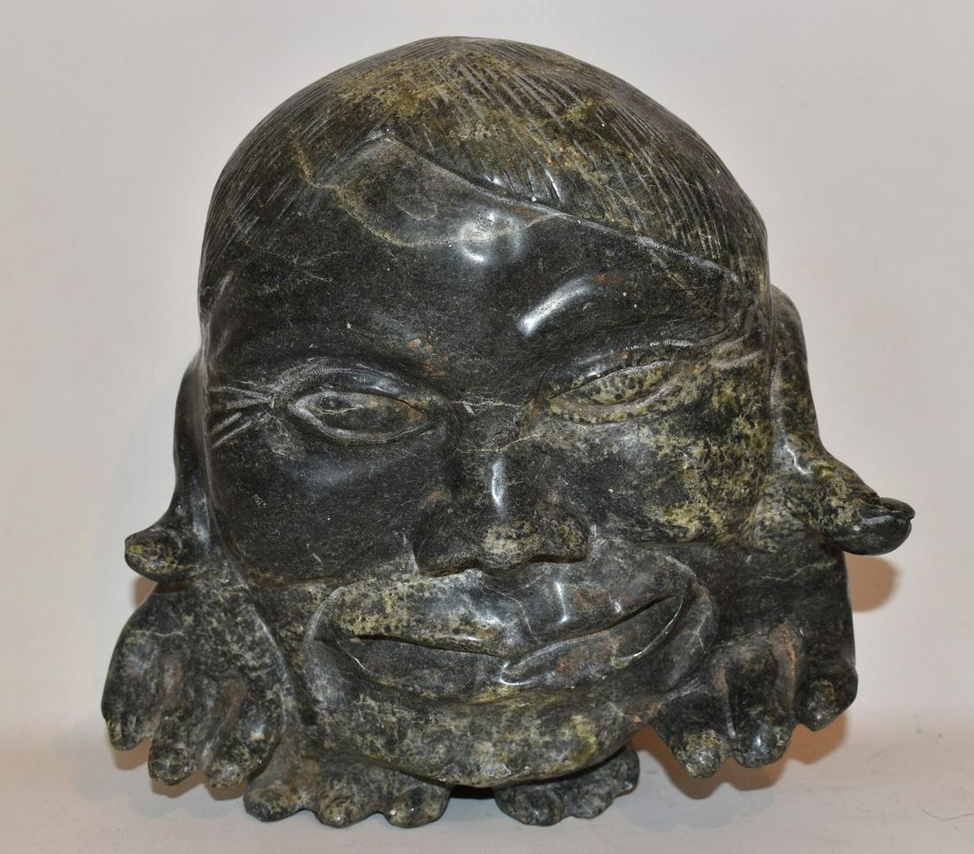 NORTHWEST COAST (INTUIT) CARVED GREEN SOAPSTONE HEAD: NORTHWEST COAST (INTUIT) CARVED GREEN SOAPSTONE HEAD OF AN ESKIMO SIGNED ILLEGIBLE, 20TH C., H. 9" W. 9"