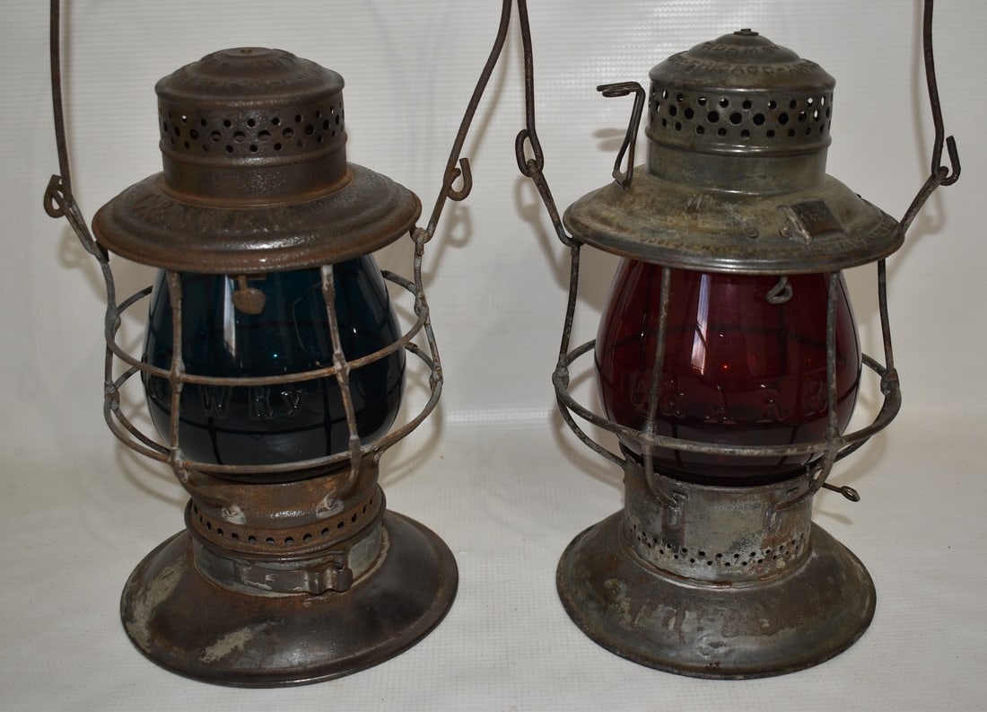 (2) EARLY RAILROAD LANTERNS INCL. C & A RR/C & N.W. RR: LOT (2) EARLY RAILROAD LANTERNS INCL. C & A RR/C & N.W. RR, 19TH C., EMBOSSED GREEN/RED GLOBES BELL BOTTOM (GREEN GLOBE CRACKED)