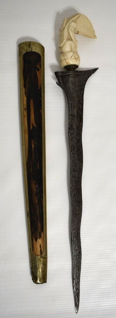 INDONESIAN DAMASK DAGGER W/CARVED BOAR TUSK HANDLE: INDONESIAN DAMASK DAGGER W/CARVED BOAR TUSK HANDLE, 19TH C., L. 19"