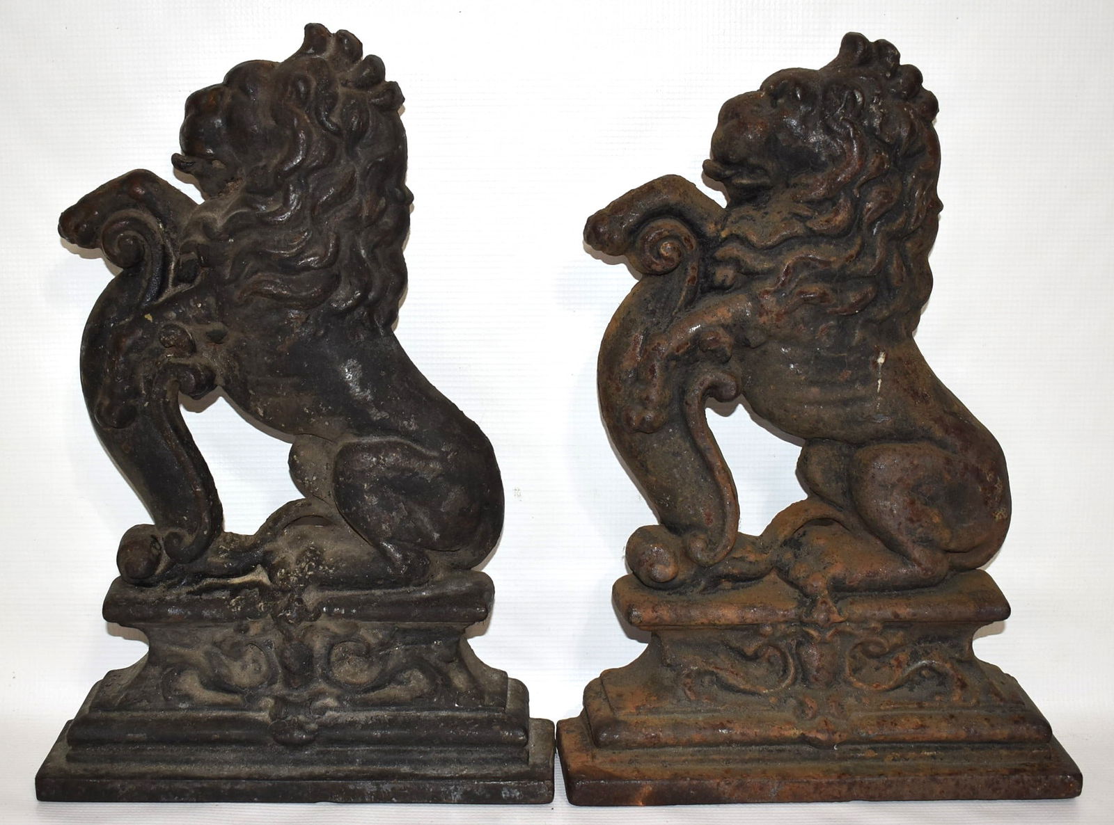 (2) VICTORIAN CAST IRON SEATED LION DOORSTOPS, 19TH C.: LOT (2) VICTORIAN CAST IRON SEATED LION DOORSTOPS, 19TH C., H. 14 1/2"