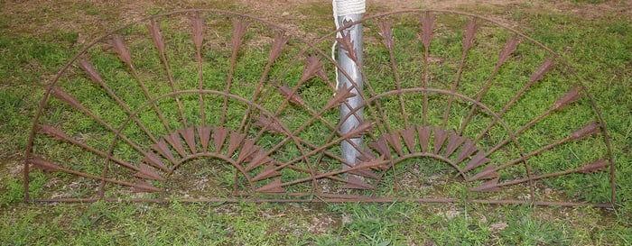PAIR DECO WROUGHT IRON ARROW WINDOW GRATES, 20TH C.