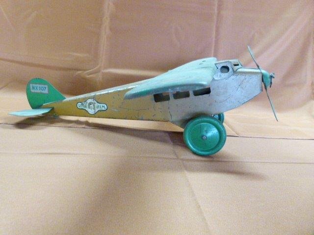 JC Penny Little Jim NX 107 Pressed Steel Airplane 1930: JC Penny Little Jimnx 107 Pressed Steel Airplane 1930 Dimensions: 22" Condition: Good For Age, Some Paint Loss Provenance: Howard "Bud" Schroder Collection