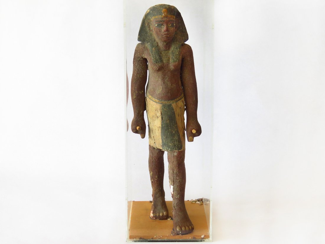 ANCIENT EGYPTIAN PAINTED/ KILTED STANDING MALE: A Carved and painted gesso over wood Egyptian standing figure, Plexiglas sealed case with vent holes CASED, BC; H. 15"