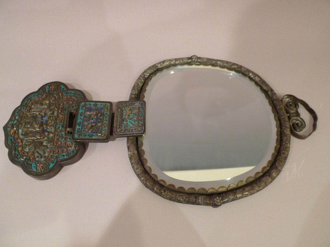 CHINESE ENAMEL SILVER AND BRONZE WALL MIRROR W/ DRAGON: Stunning Chinese enamel on silver and bronze wall hanging mirror. Silver frame with hand chased scroll design and Chinese characters. 3 hanging bronze panels with hand chased scenes of gold fish, bird