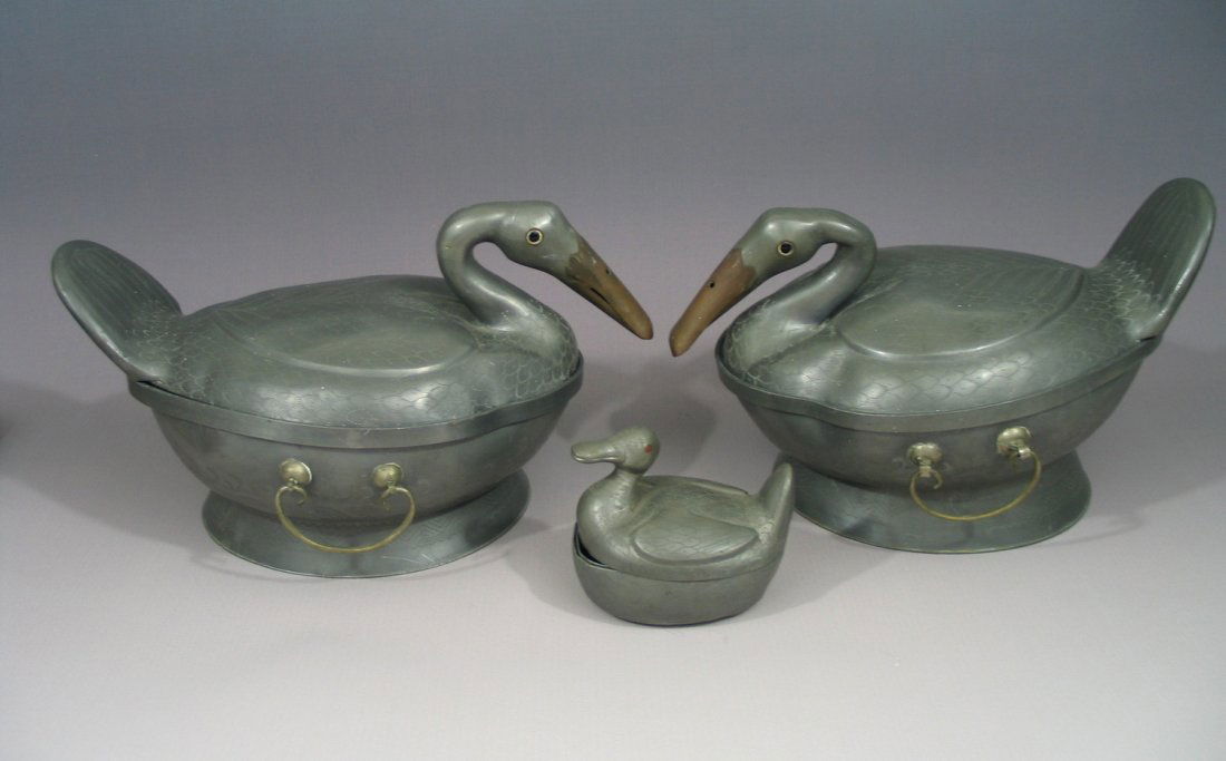 Chinese duck-shaped metal soup bowls with handles,: Chinese duck-shaped soup metal bowls, Early 20th Century. Big duck measures 7 - 7 1/2 inches tall and 12 - 12 1/2 inches long. The small duck measures 3 1/2 inches tall and 4 1/4 inches long. Maker's