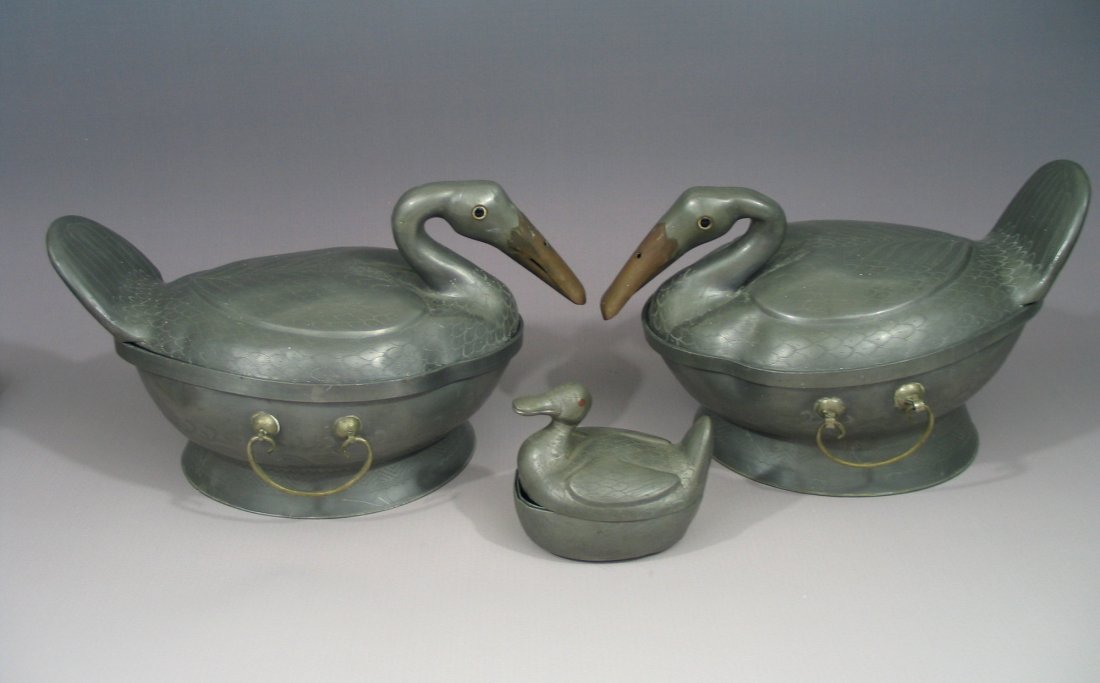 Chinese antique duck-shaped tin soup bowls: Chinese antique duck-shaped soup bowls, Big duck measures 7 - 7 1/2 inches tall and 12 - 12 1/2 inches long. The small duck measures 3 1/2 inches tall and 4 1/4 inches long. Maker's mark. Late 19th ce