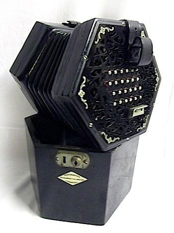 A hexagonal nineteenth century concertina in original b: A hexagonal nineteenth century concertina in original box, by Rushworths of Liverpool, the instrument with leather bellows, having ebonised ends with scrolled inlay, with leather straps and chromed mo