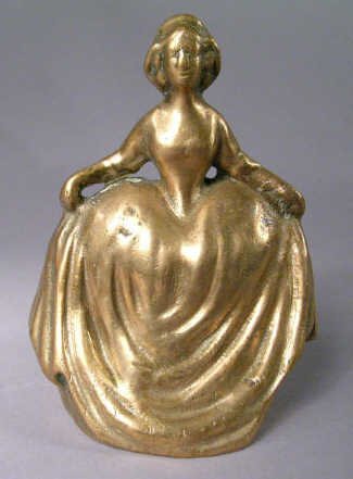 Cast Brass Gone with the Wind Paperweight: Cast brass paperweight, a lady in a long full skirt. Slightly indistinct facial features. 5"Tall x 3" diameter.