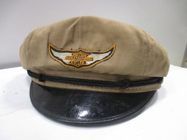 Harley Davidson Riders Cap, tan cloth, hard version to: Harley Davidson Riders Cap, tan cloth, hard version to find, great condition, coating on bill is cracked, there are some snags/small holes on the inner part of the cap only, nothing that effects the o