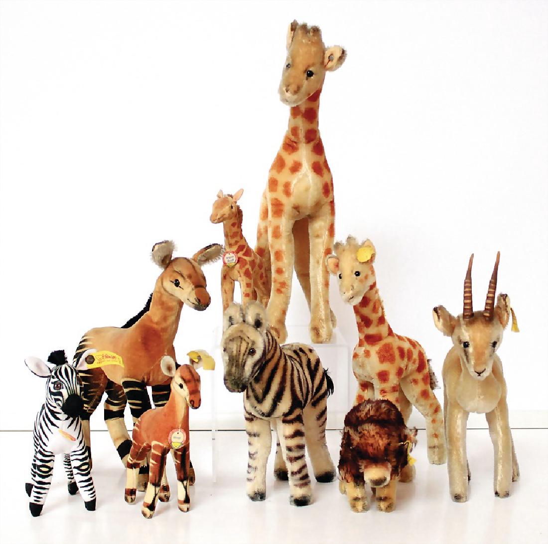 STEIFF Konv. 9-tlg., 1 Okapi, mit Knopf, Schild und: STEIFF Konv. 9-tlg., 1 Okapi, mit Knopf, Schild und Fahne Nr. 6414,00, Stehhöhe: 15 cm, 1x Antilope, mit Knopf und gelber Fahne, 3x Giraffe, untersch. Gr., 1x Zebra, 50er Jahre, 1x Zebra, neuer, 