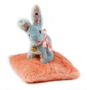 STEIFF hare on a pin-cushion, hare: 15 cm, produced: STEIFF hare on a pin-cushion, hare: 15 cm, produced between 1930-1934, with cushion: 20 cm, button, long stretched F, rests of the red cloth tag label, mohair, brown/black glass eyes, ears were streng