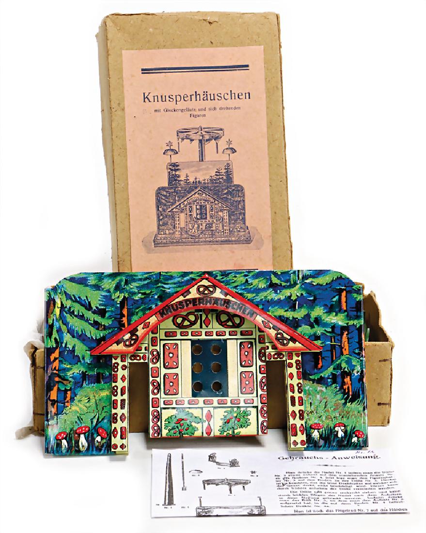 gingerbread house, (with sich turning figures),: gingerbread house, (with sich turning figures), lithographed sheet metal , 1 star on the bell is missing, otherwise good condition in original box German Description Knusperhäuschen, (mit sich drehen