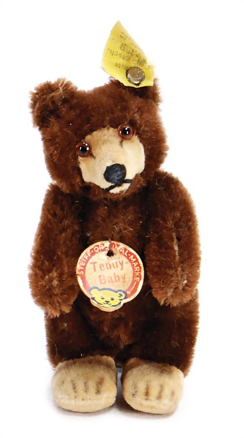 STEIFF teddy-baby, 9 cm, dark-brown, complete, No.: STEIFF teddy-baby, 9 cm, dark-brown, complete, No. 7309, sign with red writing, writing is slightly worn, No. on cloth tag label is slightly worn, good condition German Description STEIFF Teddy-Baby, 