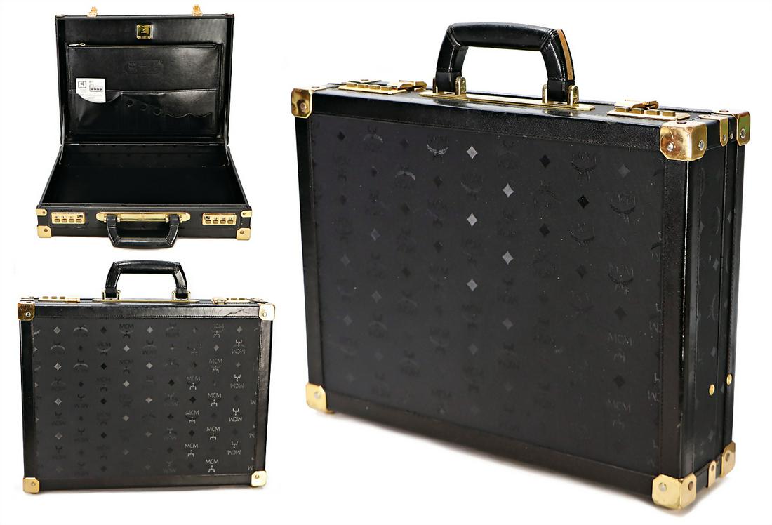 MCM suitcase, black MCM Monogramm, 1 carrying handle,: MCM suitcase, black MCM Monogramm, 1 carrying handle, gold colored fittings, lock with push buttons, inside 2 big side pockets , 4 small side pockets, 1x with zipper, gold colored badge inside, 4 feet