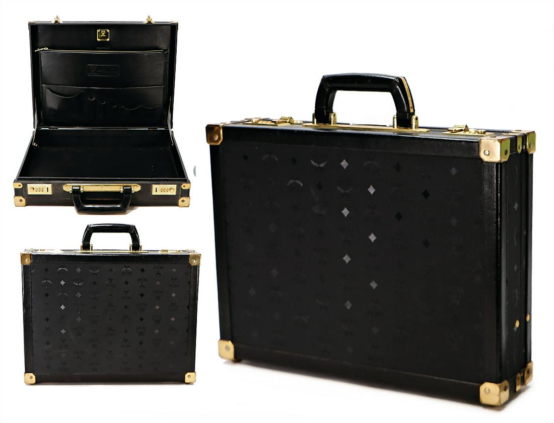 MCM suitcase, black MCM Monogramm, 1 carrying handle,: MCM suitcase, black MCM Monogramm, 1 carrying handle, gold colored fittings, combination lock, 2 big side pockets inside, 4 small side pockets, 1x with zipper, gold colored badge inside, 4 feet, width