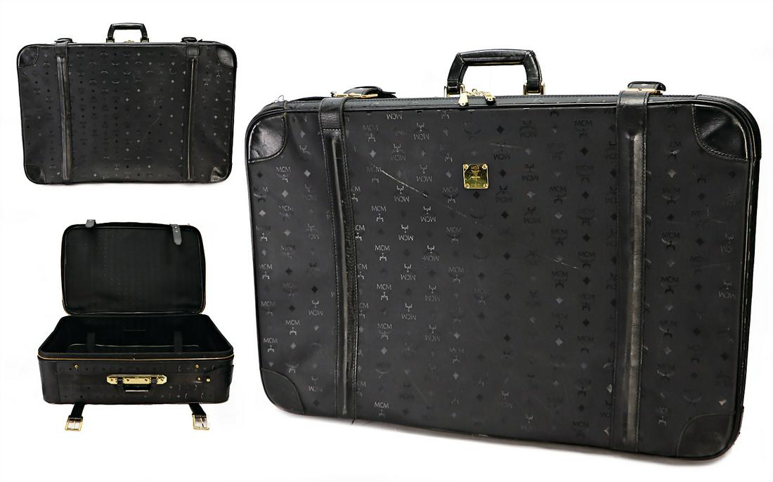 MCM suitcase, black MCM Print, golden badge in the: MCM suitcase, black MCM Print, golden badge in the middle , MCM München 0742L, designed by Michael Kromer, golden fittings, buckle, and big zipper, with pull cord, outside with clearly traces of usag