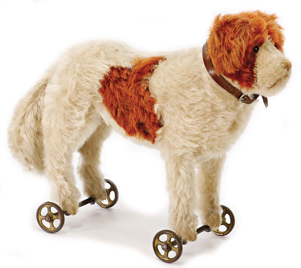 STEIFF St. Bernard dog, on metal wheels, produced from: STEIFF St. Bernard dog, on metal wheels, produced from 1905-06, shoe button eyes, small shiny button, with minimally rests of the white cloth tag label, rust-colored mohair, with original leather coll