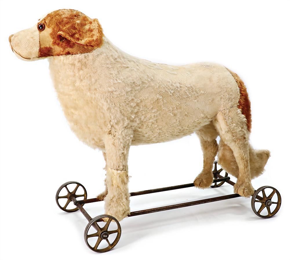 used spaniel on cast spoke wheels, glass eyes, without pull voice, mohair is strongly worn, glass: used spaniel on cast spoke wheels, glass eyes, without pull voice, mohair is strongly worn, glass eyes, heigth 43 cm, 42 cm lenght, probably Steiff German Description bespielter Spaniel auf Gussspeich
