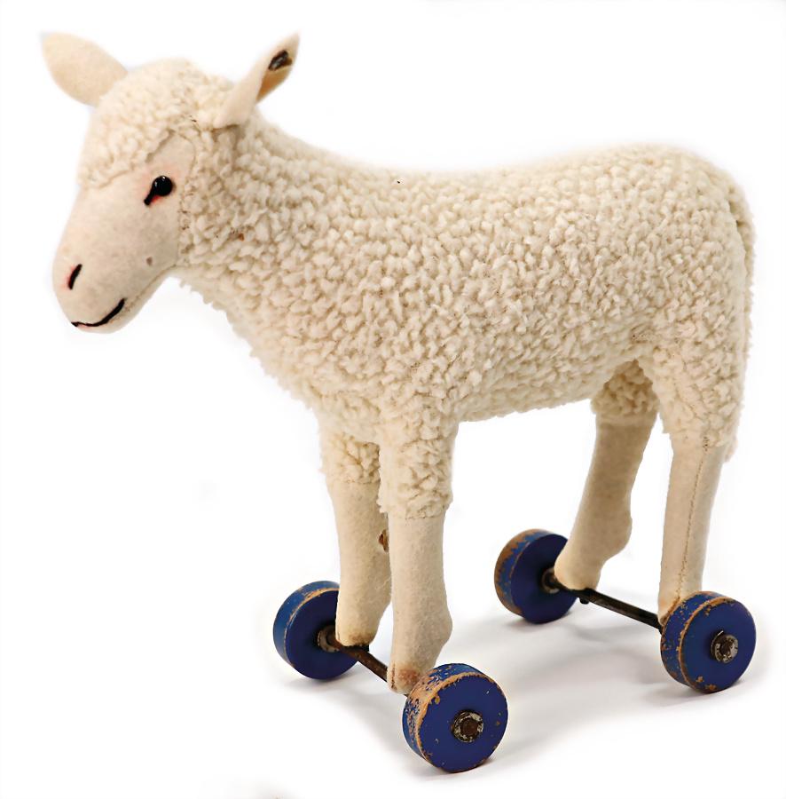 STEIFF lamb on wooden wheels, lenght: 20 cm, height: 18 cm, with button, long trailing f, rests of (1 of 1)