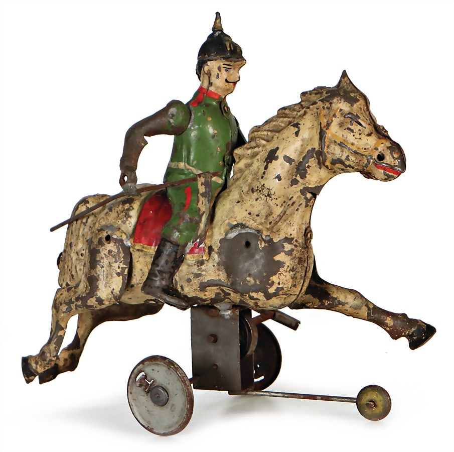 rider on horseback with cloth tag label, clock mechanism is faulty, used condition, height: 15 cm,: rider on horseback with cloth tag label, clock mechanism is faulty, used condition, height: 15 cm, length: 18 cm, sheet metal, lithographed, partially with flaked off paint parts German Description Re