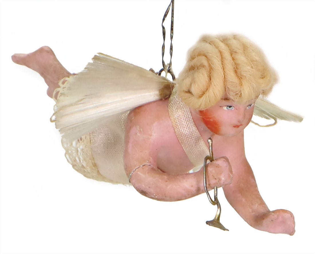 wax Christmas angel with trombone, glass tail-wing, around 1900, 12.5 cm, 1 arm was glued German: wax Christmas angel with trombone, glass tail-wing, around 1900, 12.5 cm, 1 arm was glued German Description Wachs-Weihnachtsengel mit Posaune, Glasschweif-Flügel, um 1900, 12,5 cm, 1 Arm geklebt