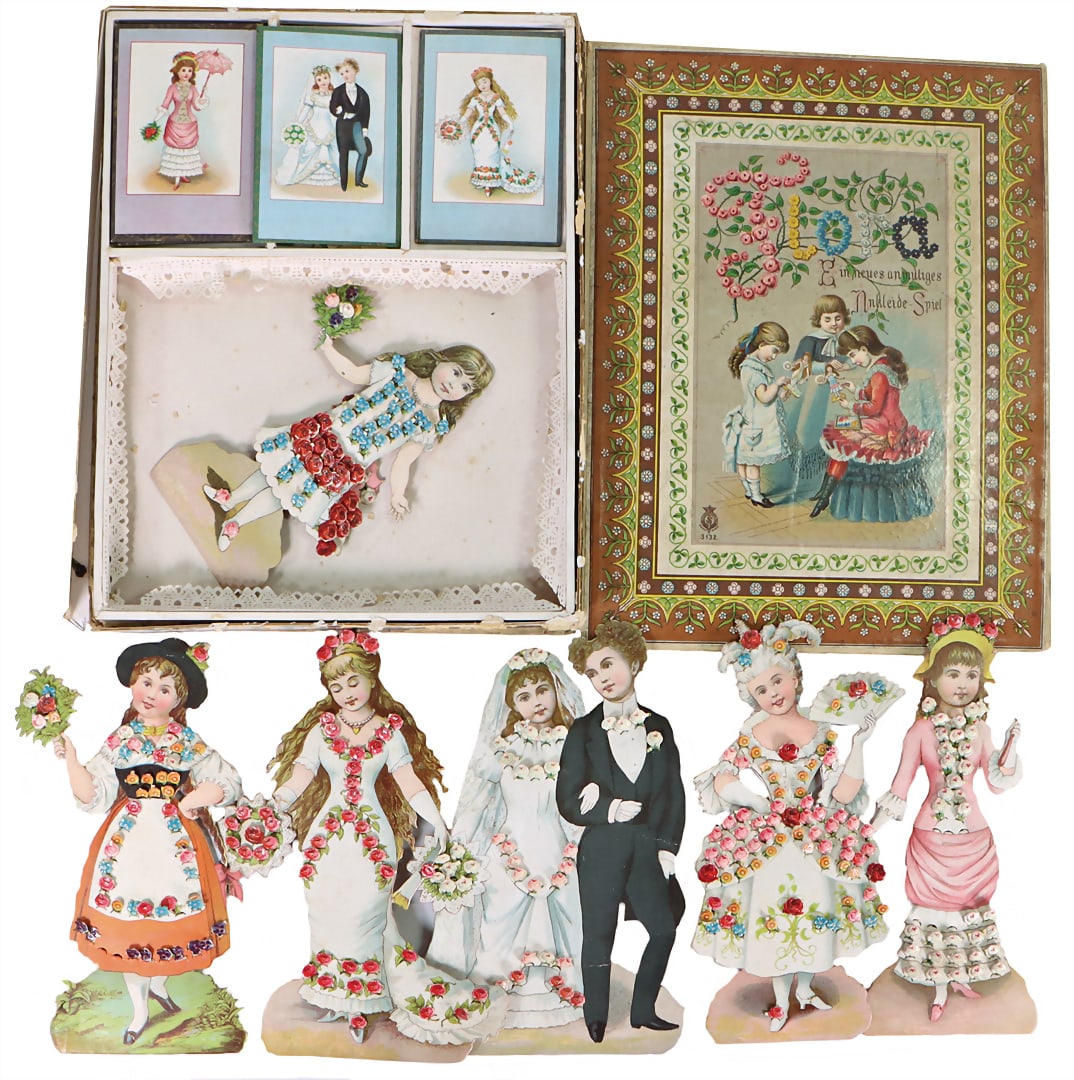 Dressing game, c. 1900, orig. cardboard, with colorful lithographed cover picture, richly decorated.: Dressing game, c. 1900, orig. cardboard, with colorful lithographed cover picture, richly decorated. accessories, loose edge on cardboard, cover picture in very nice condition, unusual, "Spielzeugmuse