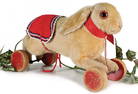 STEIFF pre-war hare on eccentric wheels, wood, l: 36 cm, mohair loss at the head, otherwise good
