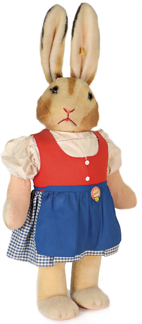STEIFF HANSILI rabbit, 69 cm, complete, no. on flag: hardly recognizable, felt soles and clothes a: STEIFF HANSILI rabbit, 69 cm, complete, no. on flag: hardly recognizable, felt soles and clothes a little bit dirty, small missing parts at the felt jacket, nice size. German Description STEIFF HANSIL