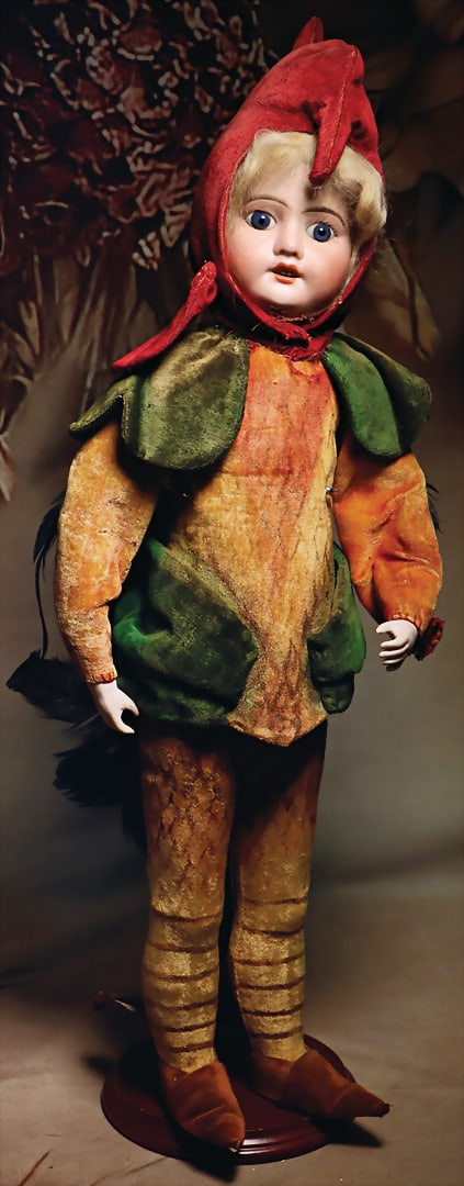 Fancy candy container, bisque porcelain head, fixed blue glass eyes, off. mouth, row of teeth on: Fancy candy container, bisque porcelain head, fixed blue glass eyes, off. mouth, row of teeth on top, dressed as a rooster, velvet clothing, with airbrush painting, bisque forearms, with feathers and 