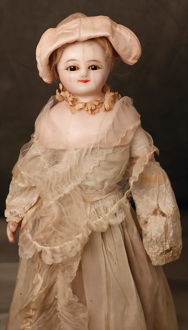 wax coated papier mâché doll, England, c. 1880, 43 cm, shoulder headed, later glued on: wax coated papier mâché doll, England, c. 1880, 43 cm, shoulder headed, later glued on mohair, dark fixed glass eyes, closed mouth, age-related stress cracks, fabric body, wax coated mass ar